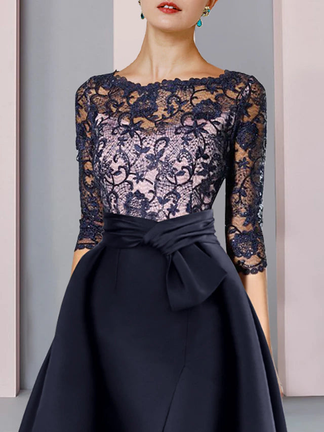 Back view of a formal satin and lace gown with a sweep train.