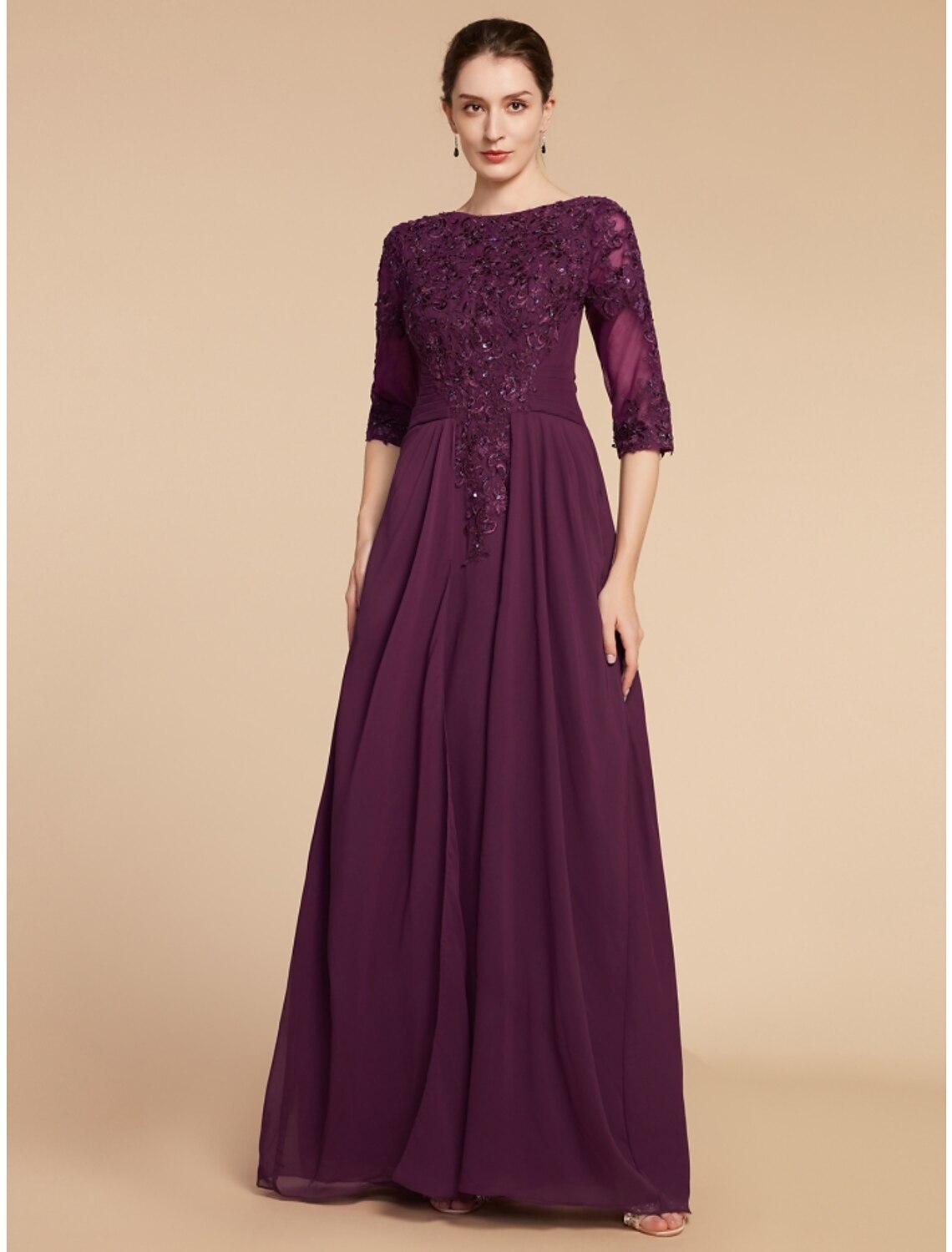 Side profile of a woman wearing a formal chiffon and lace gown.