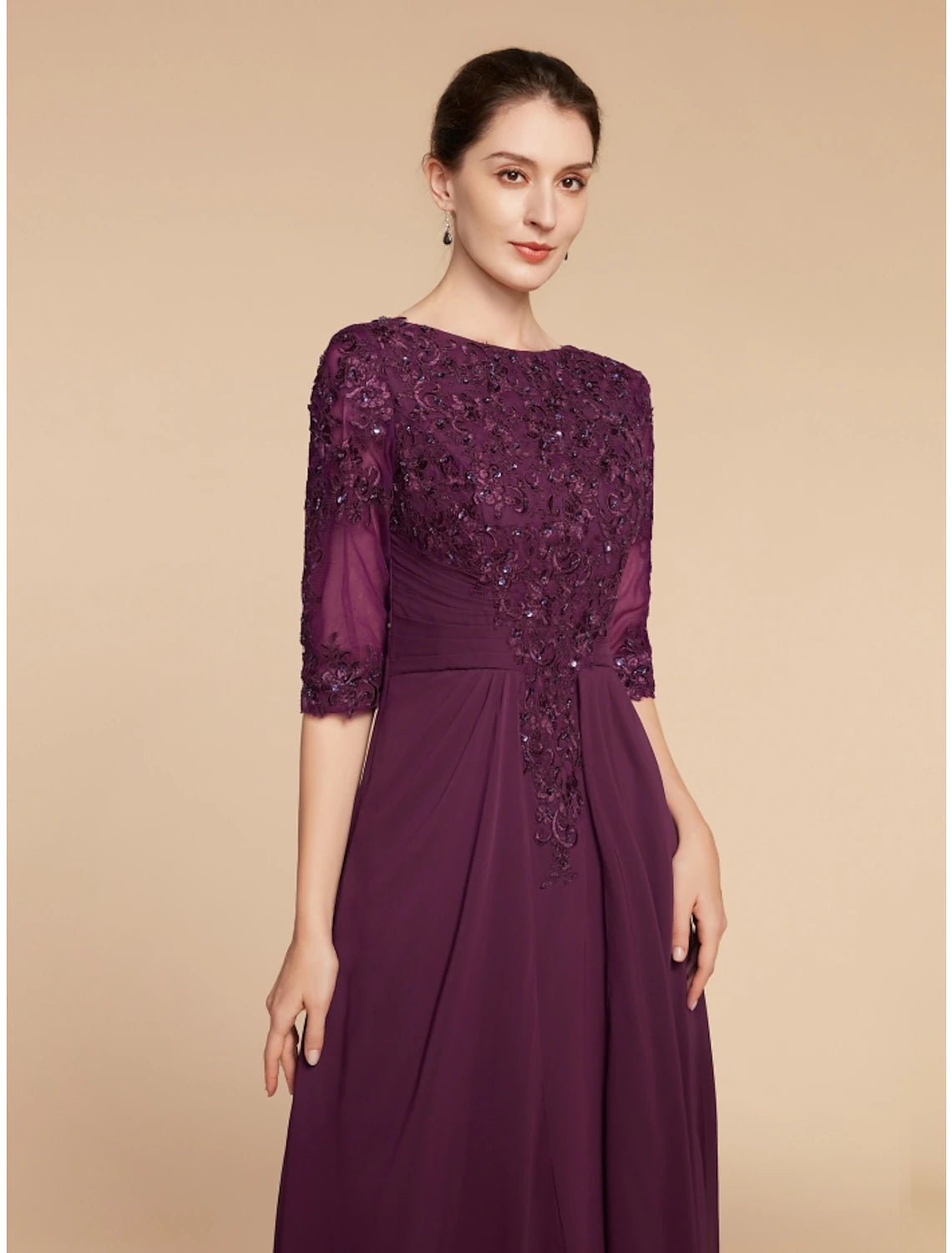 Detailed view of the pleated skirt and sequin accents on the formal gown.