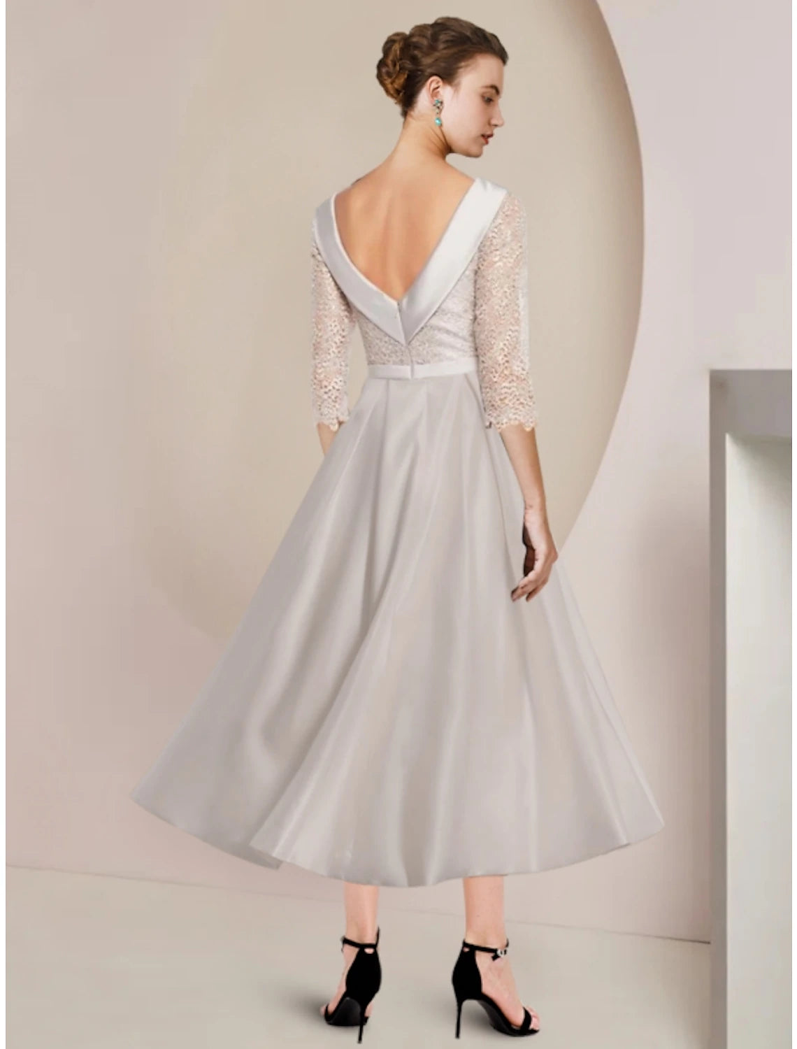Back view of the elegant sheath dress, showcasing the tea length and fabric details.