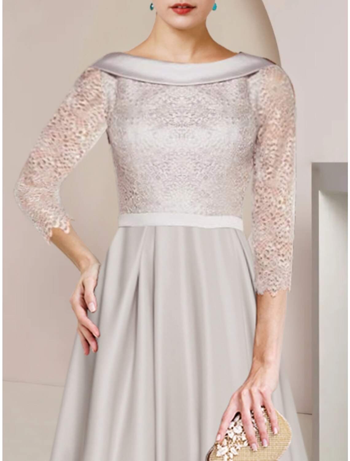Close-up of the satin and lace fabric with ruching detail on the elegant tea length dress.