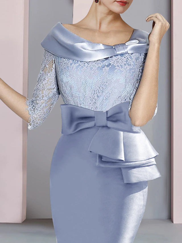 Close-up of lace and satin fabric with bow on a half-sleeve dress.