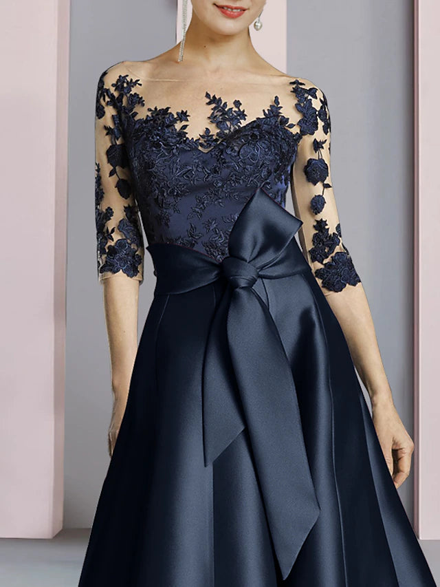 Back view of the elegant ankle-length satin lace dress with bow details.
