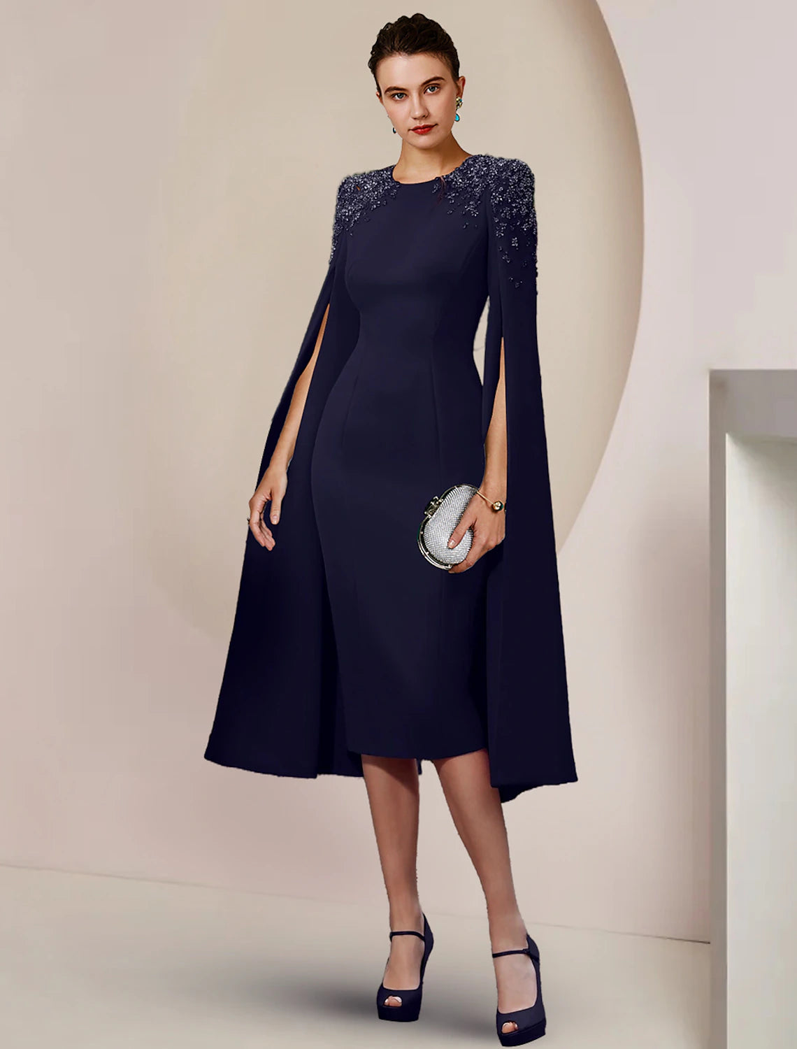 Side view of the woman in the elegant scoop neck sheath dress.