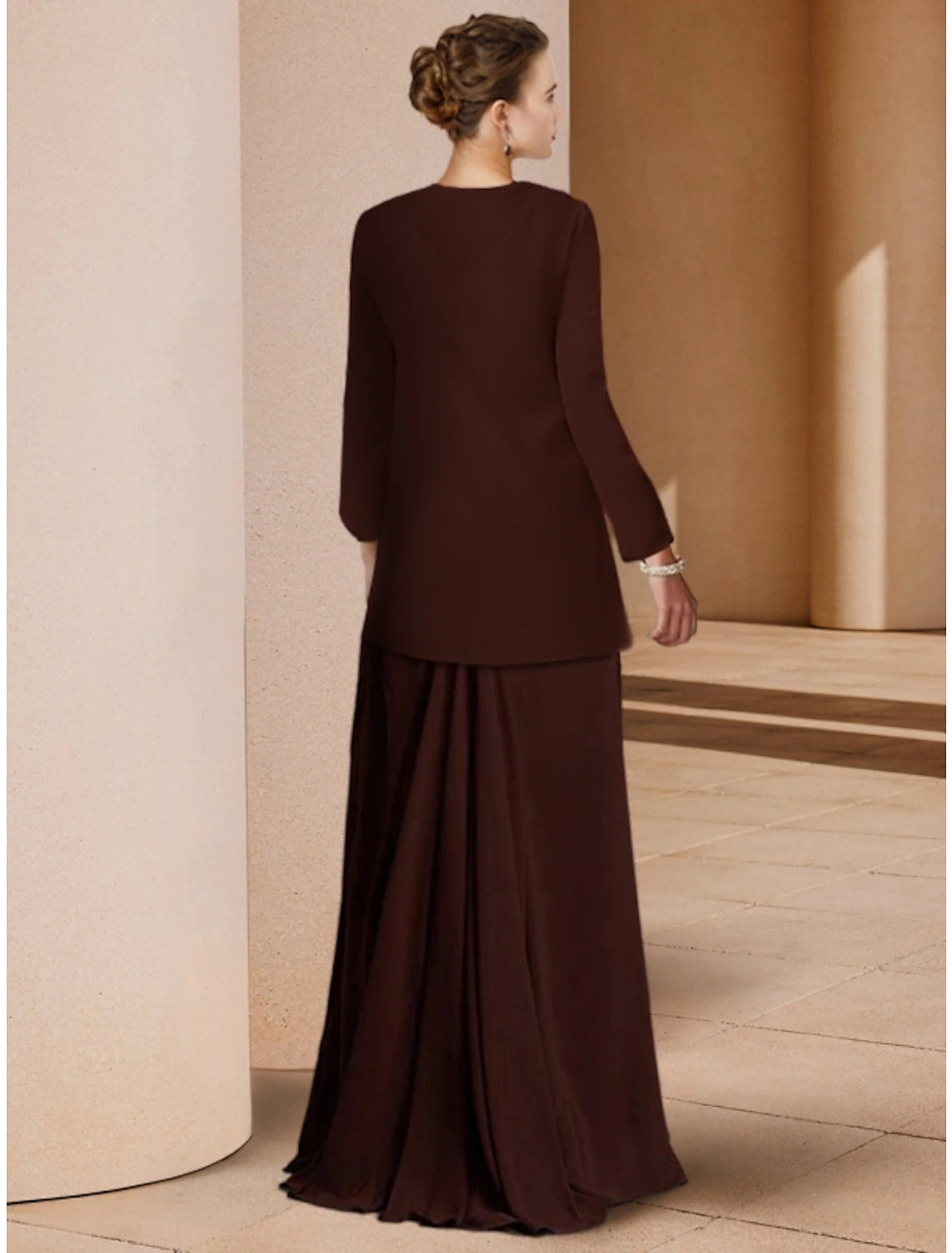 Back view of the floor length sheath dress showing sequin embellishments.