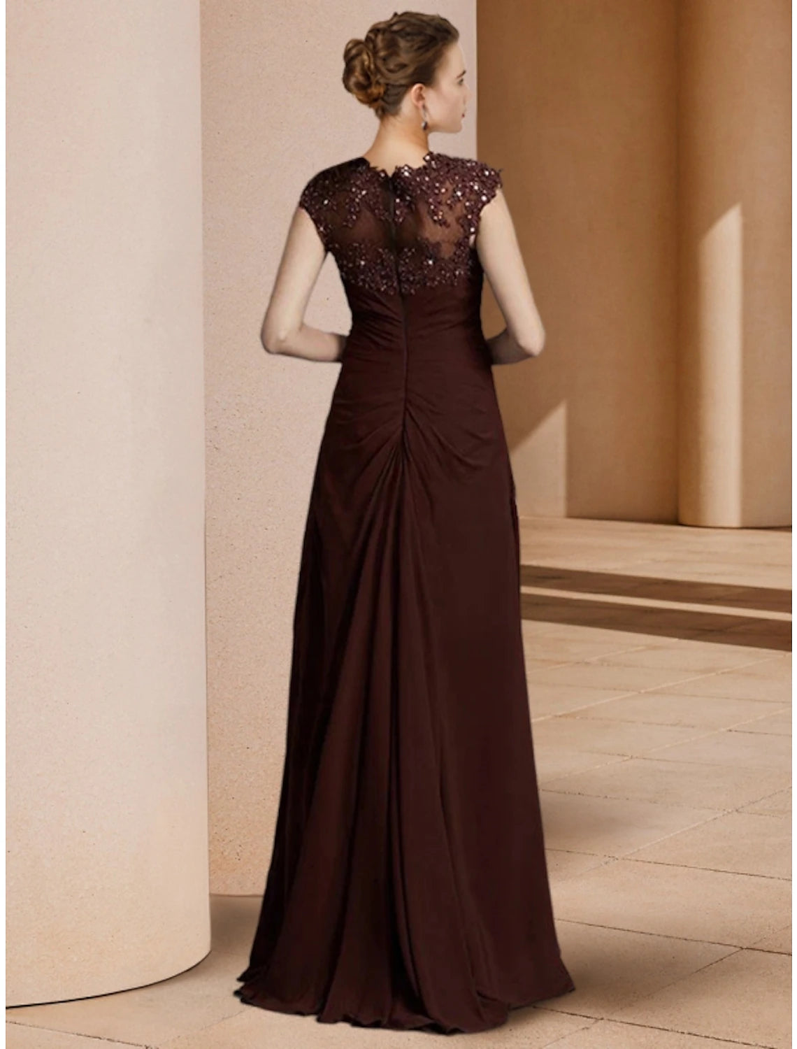 Close-up of the sequin and ruched detailing on the dress.