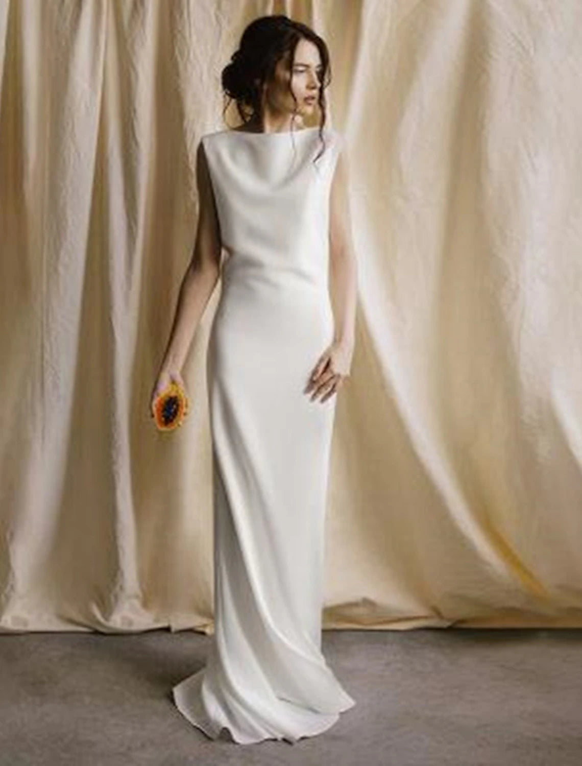 Elegant satin sheath wedding dress with a scoop neck and open back, featuring a sweep train.
