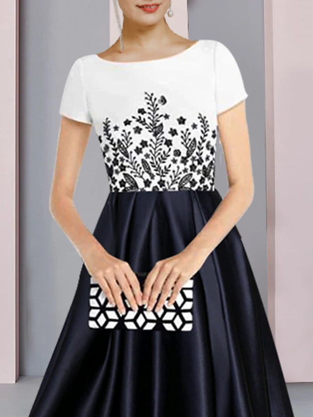 Side view of a woman wearing a formal short-sleeve satin dress with an asymmetrical design.