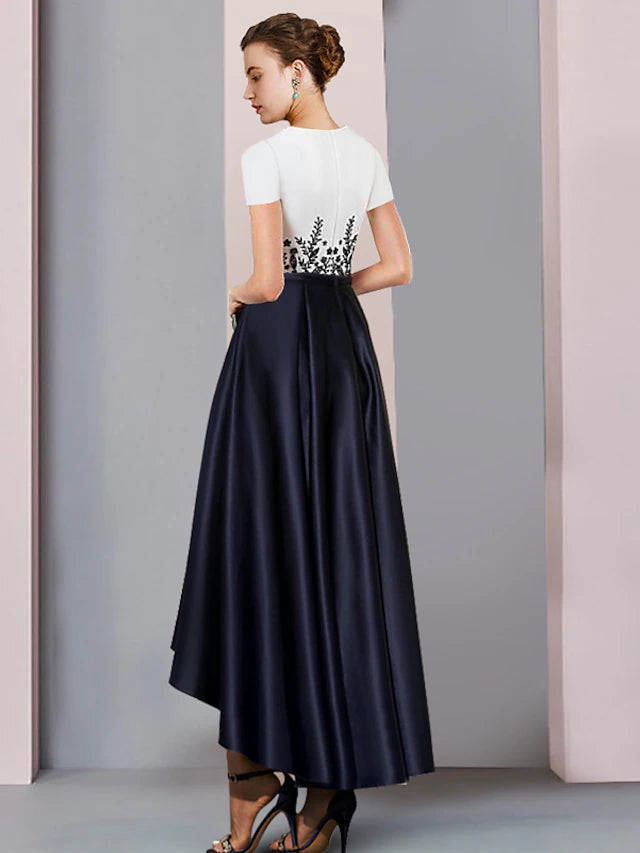 Close-up of the satin fabric and delicate appliques on the short-sleeve formal dress.