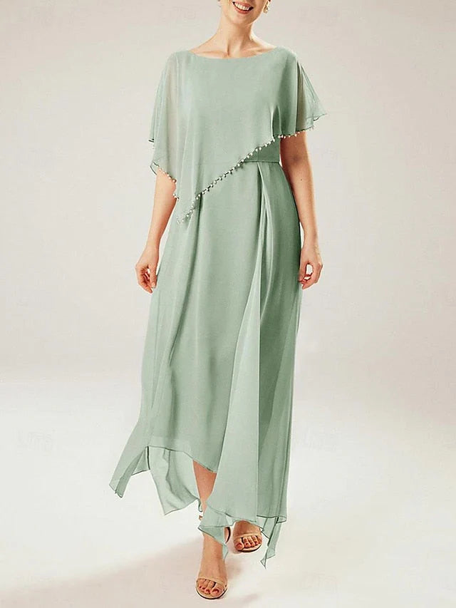 Woman wearing a blue sheath mother of the bride dress with short sleeves.