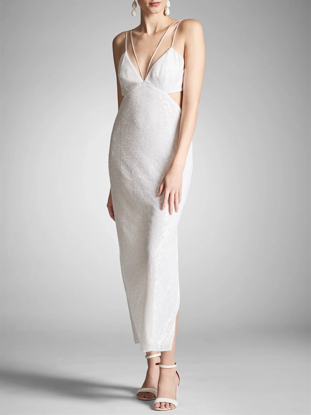 Woman wearing an elegant sheath maxi dress with spaghetti straps.