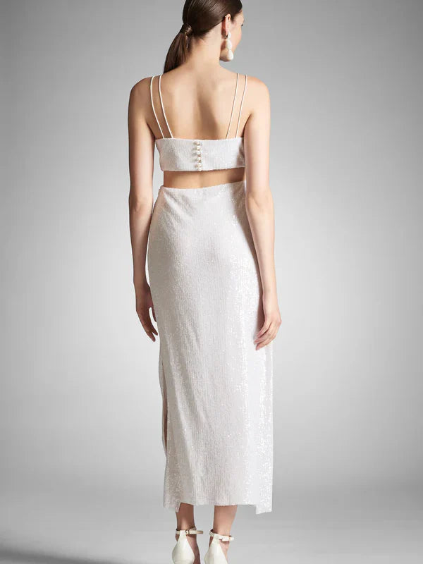 Back view of a woman in a spaghetti strap sheath dress.