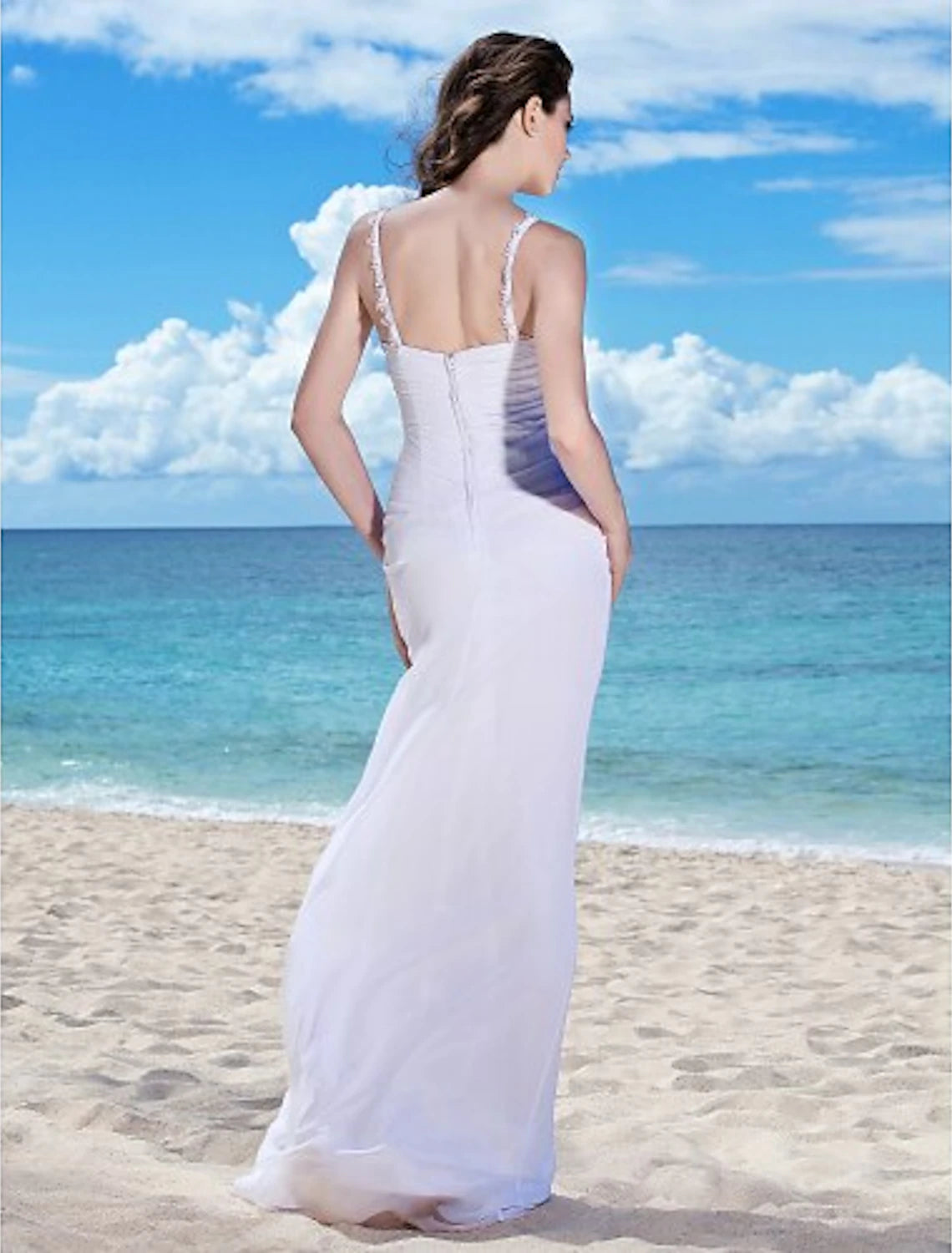 Back view of a floor-length bridal gown with ruched details.