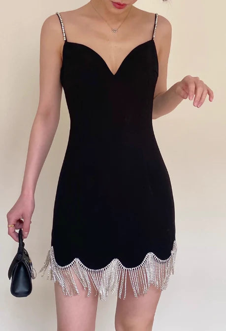 Chic sheath dress with spaghetti straps and tassel beading.