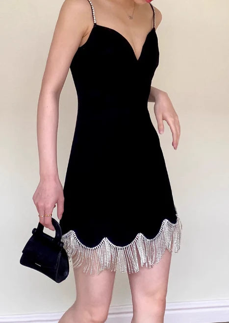 Elegant short dress featuring spaghetti straps and tassel details.
