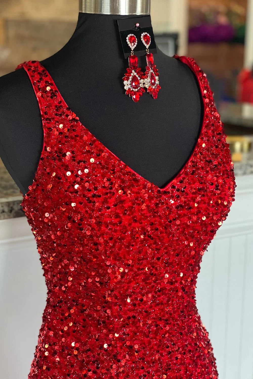 Back view of the red sequin sheath prom dress, showing the delicate spaghetti straps.