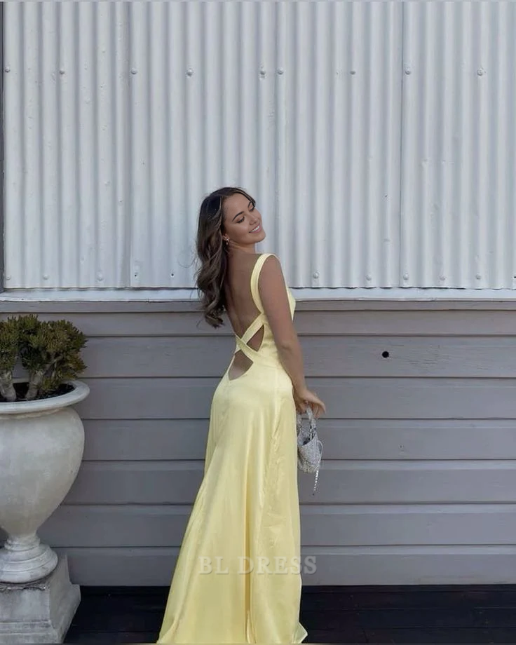 Back view of a long yellow satin formal dress.