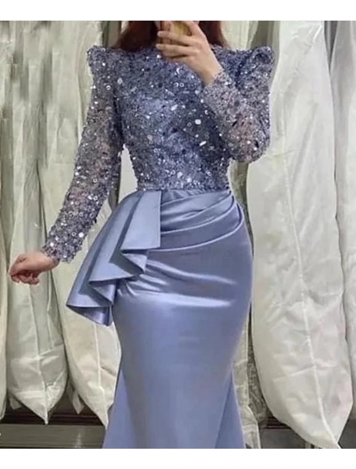 Side view of a black formal dress, showing stretch fabric and tea length.