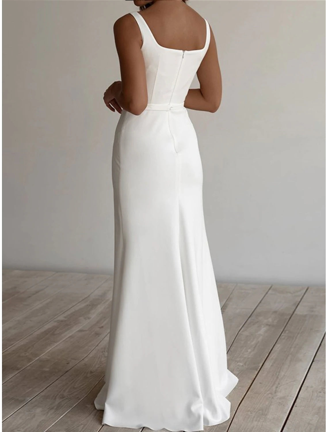 Full view of a sleeveless white floor-length bridal gown with a square neckline and stretch fabric.