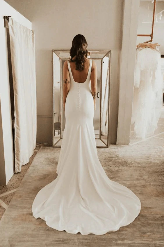 Back view of the long backless sheath wedding dress.