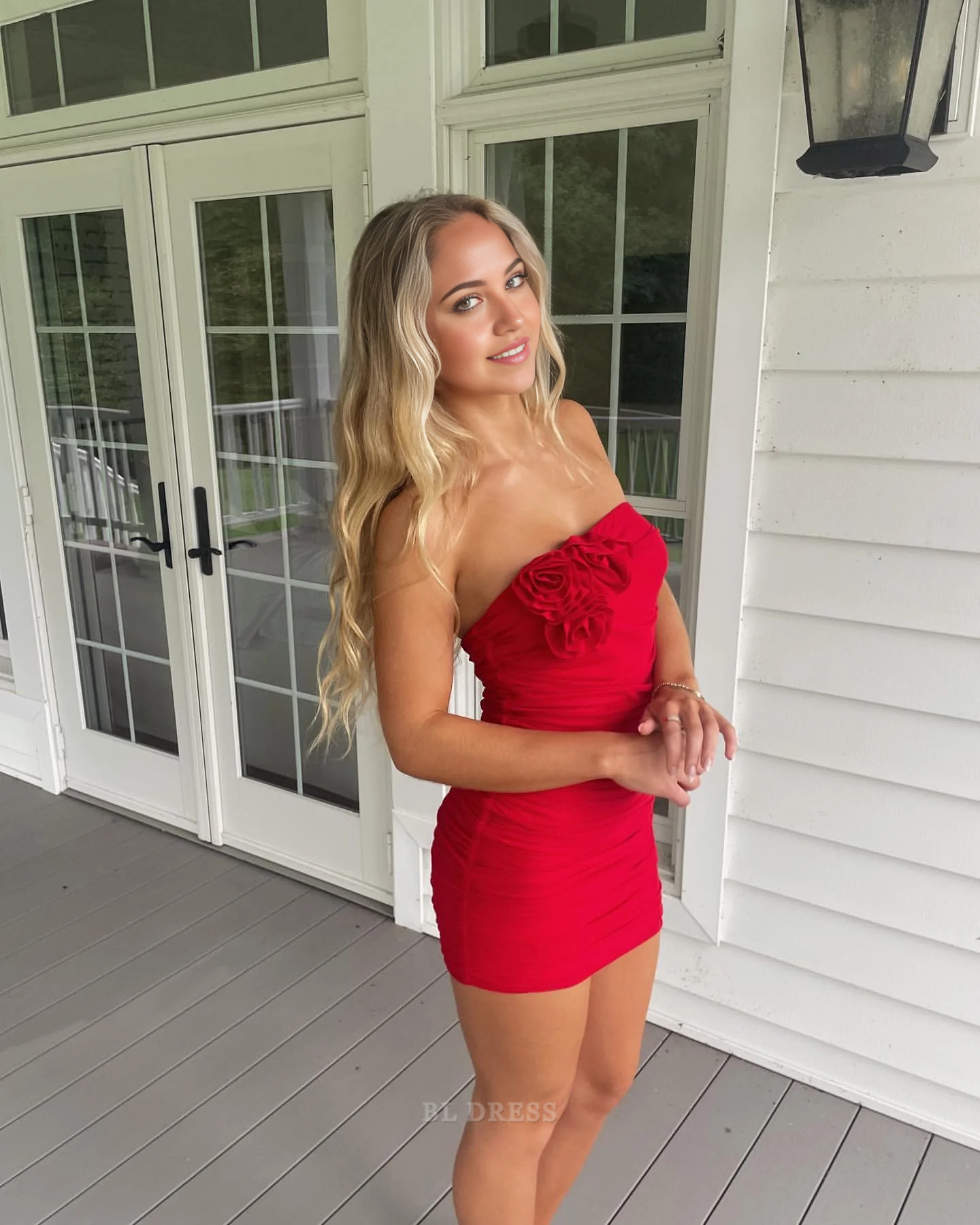 Back view of a red strapless sheath prom dress.