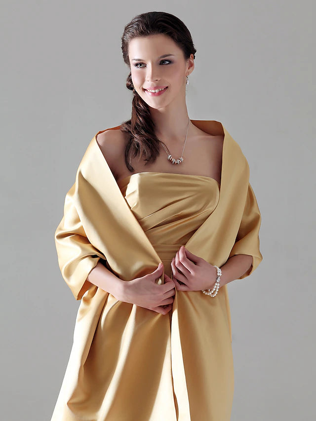 Strapless floor length satin gown with a column silhouette and side draping.