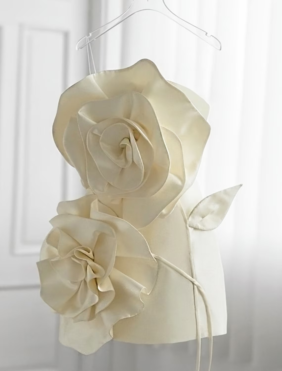 Model wearing an elegant floral satin sheath homecoming dress with ruffles.
