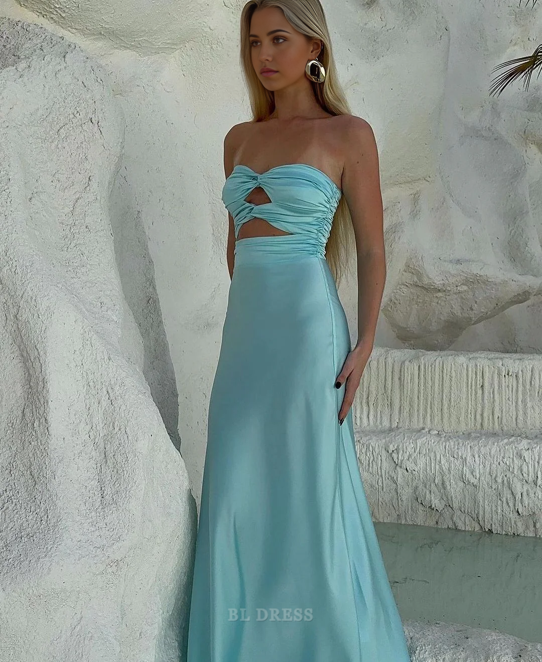 Woman wearing a sophisticated strapless evening gown.
