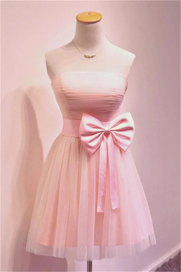 Front view of a short pink strapless sheath homecoming dress.