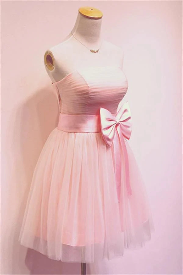 Side view of a short pink strapless sheath homecoming dress.