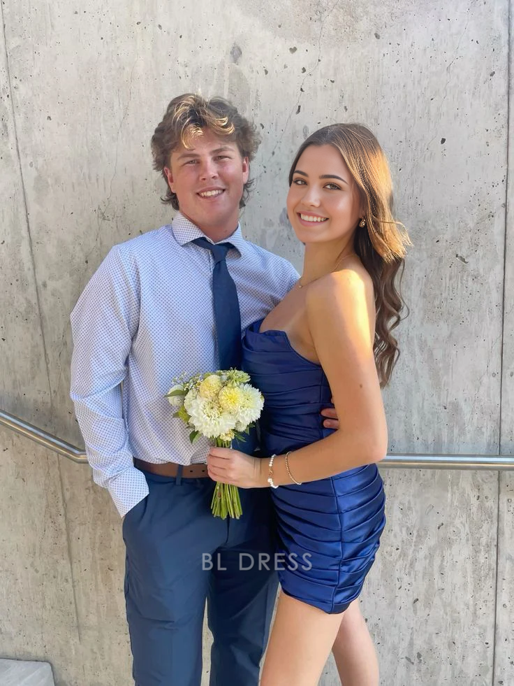 Woman wearing a royal blue strapless sheath short formal dress.