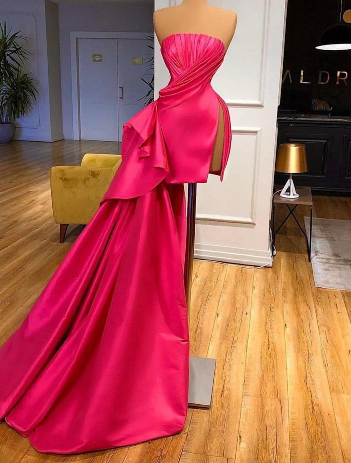Model wearing a pink strapless ruched satin mini cocktail dress.