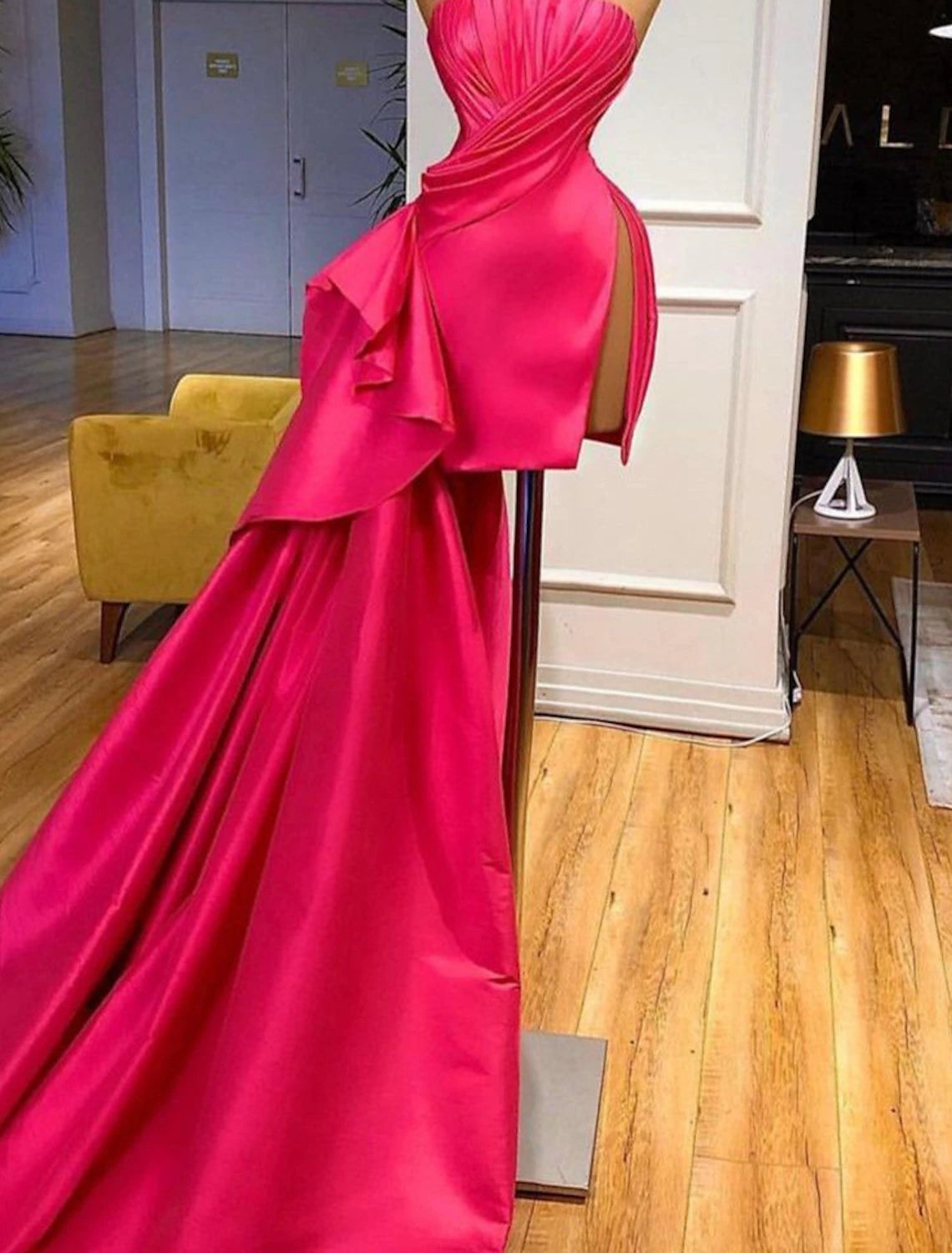 Model posing in a vibrant pink Barbiecore sheath cocktail dress.