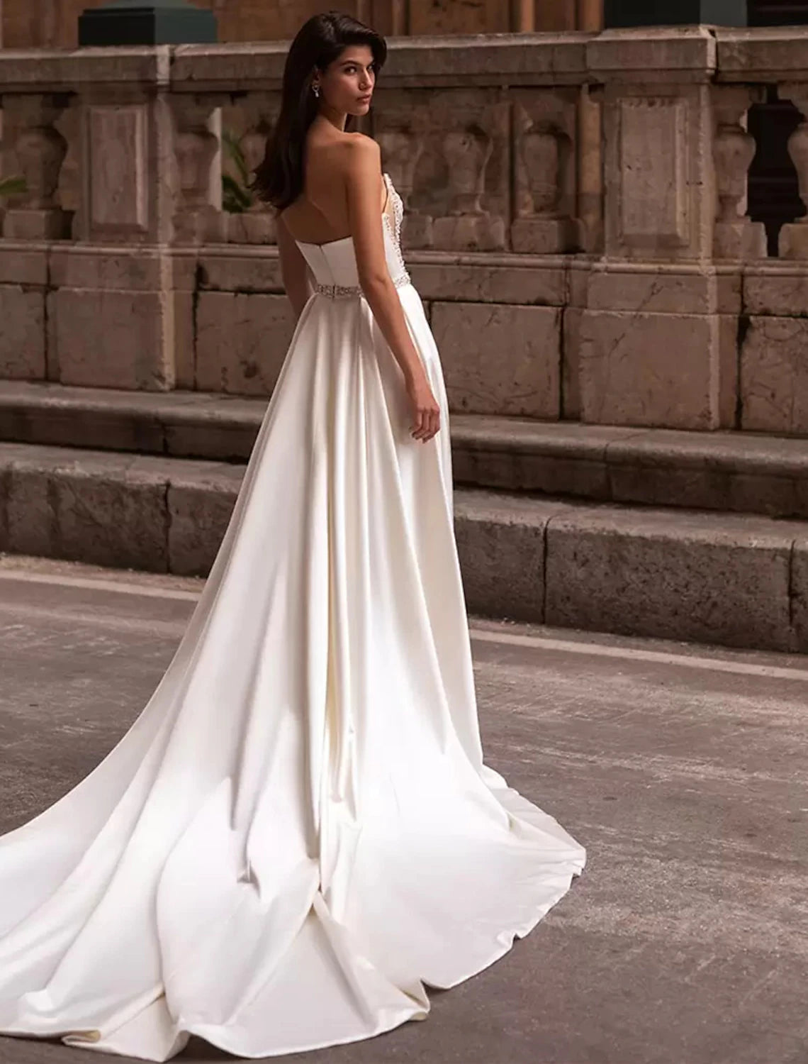 Elegant strapless square neck sheath wedding gown with a split front and chapel train.