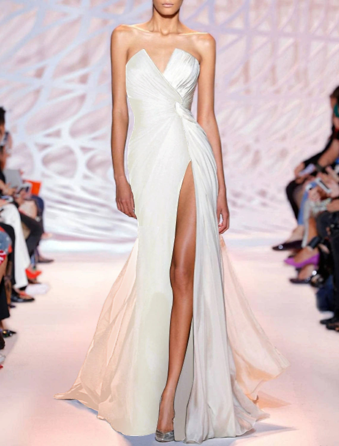 Close-up of the white polyester fabric and strapless neckline of the evening gown.