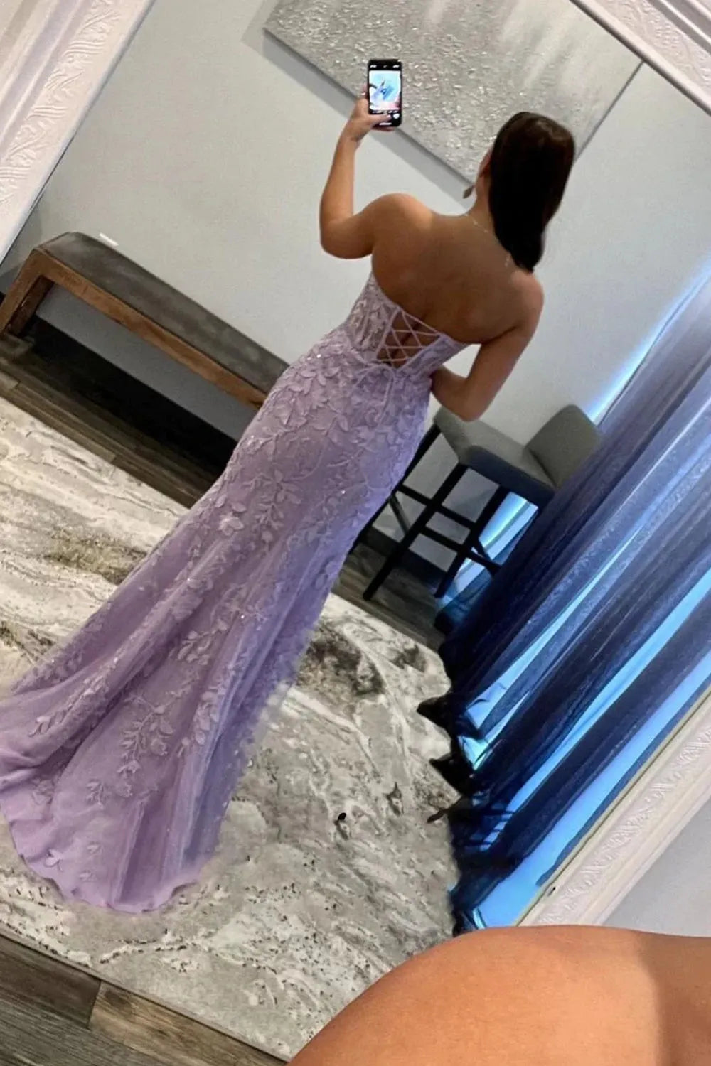 Model posing in the dark blue prom dress, showing the full length and flowing skirt.