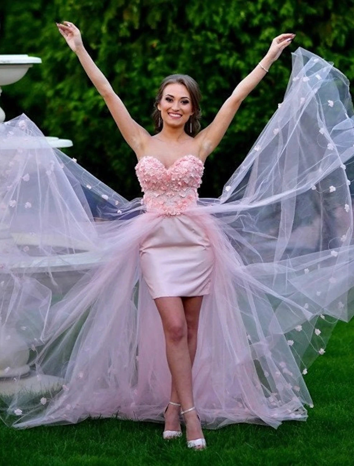 Close-up of the delicate embroidery and appliques on the tulle prom dress.