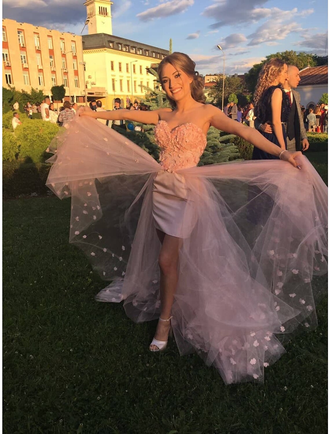 Side view of the high-low prom dress highlighting the silhouette and hemline.