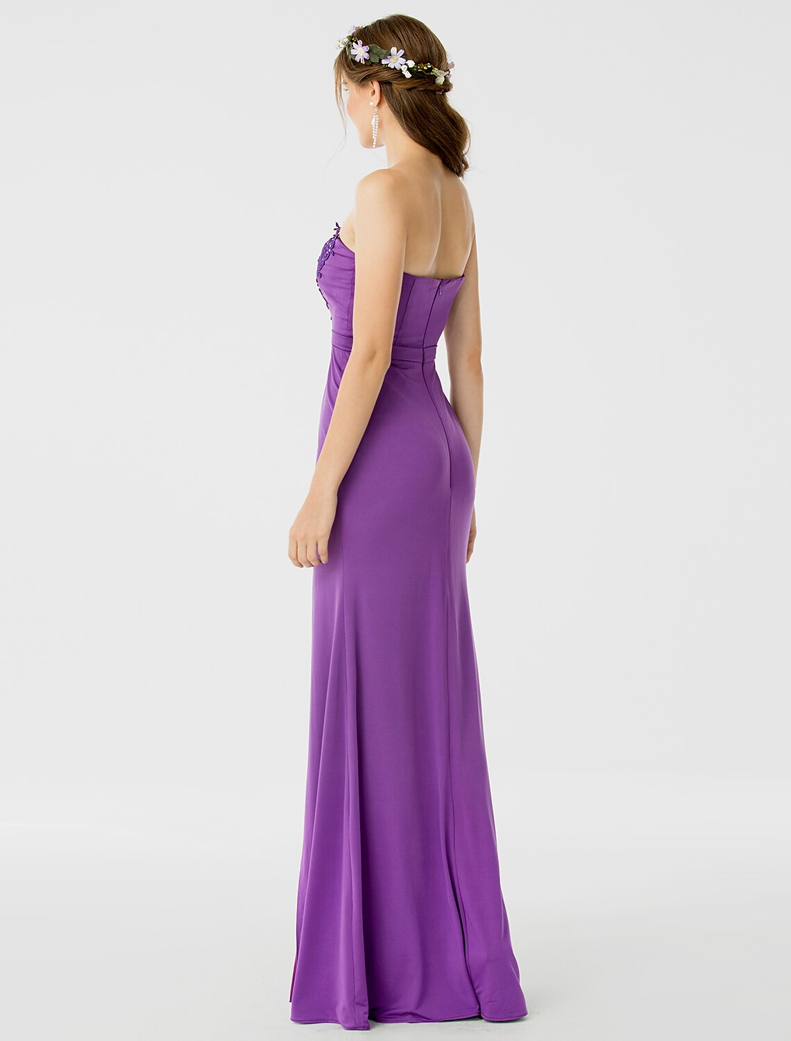 Close-up of the sweetheart neckline and delicate lace appliques on the bridesmaid dress.