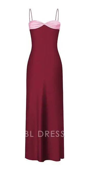 Elegant woman wearing a dark sheath sweetheart neck spaghetti strap formal dress.