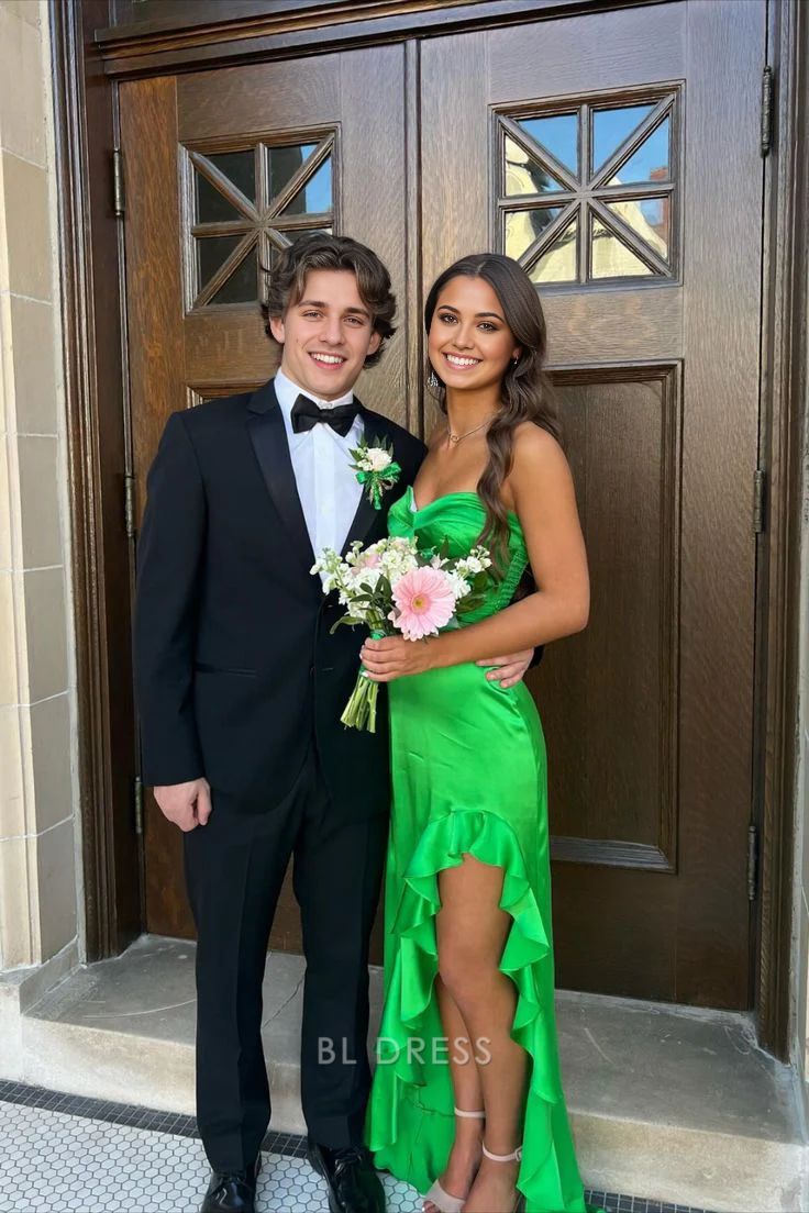 Green sheath formal dress with sweetheart neckline, ruffles, and a high leg slit.