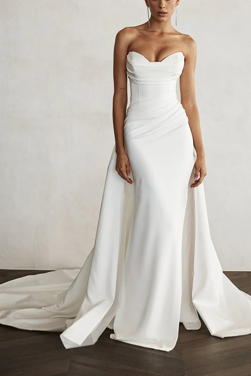 Back view of a sleeveless ankle-length satin bridal gown.