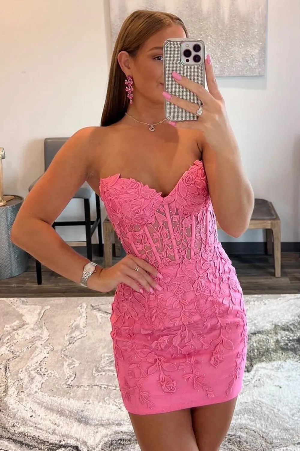 Model posing in the short formal dress with appliques.