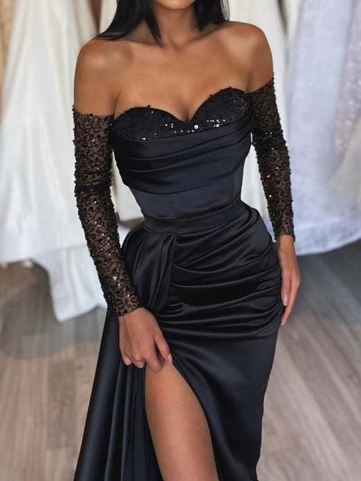 Back view of a model in a sleeveless sheath sweetheart floor length formal dress.