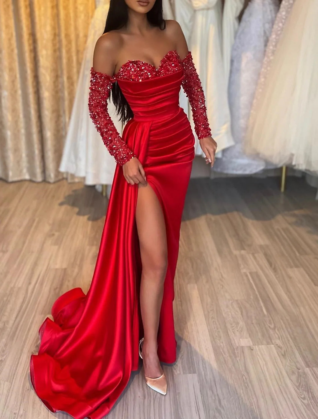 Side view of a model showcasing a sleeveless sheath sweetheart floor length prom gown.