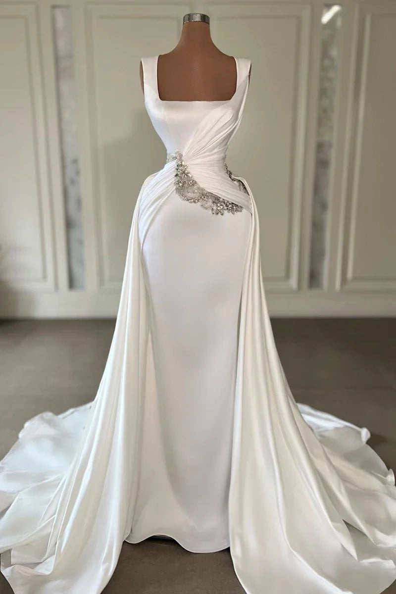 Elegant satin sheath wedding dress with sweetheart neckline and spaghetti straps.