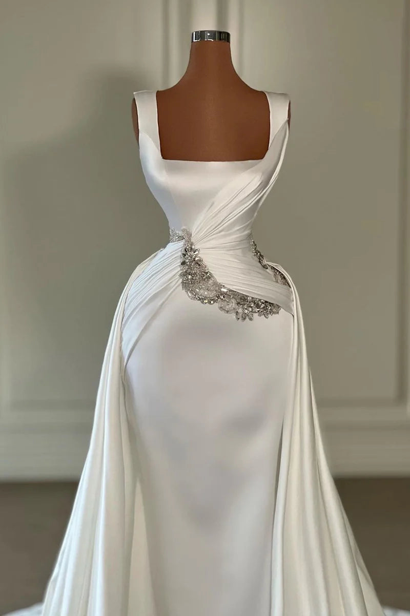 Satin bridal gown featuring a split front and side-draped detail with court train.
