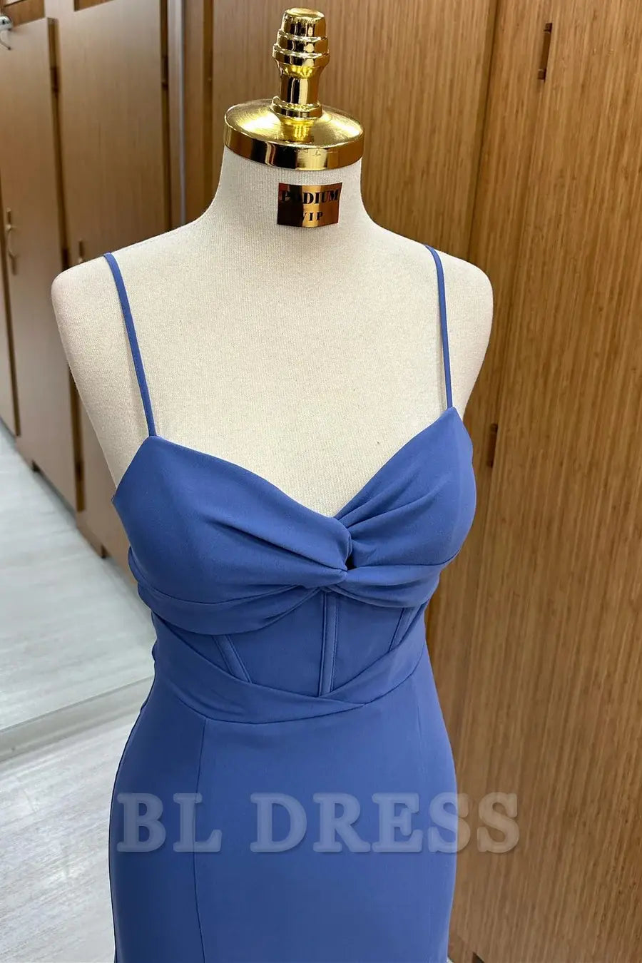Long navy formal gown with elegant twist-front design.