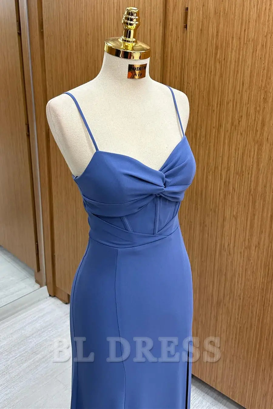 Navy formal dress featuring delicate spaghetti straps.