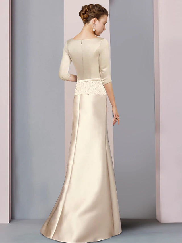 Woman wearing a floor-length sheath gown with V-neck, 3/4 sleeves, and delicate lace accents.